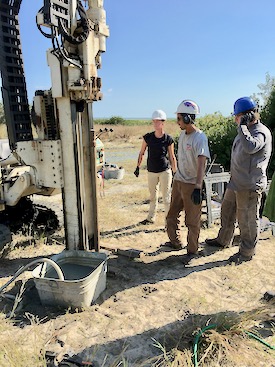 Dr. Chris Hein (C) prepares to collect a sediment core from a barrier island with VIMS colleagues Jennifer Connell (L) and Justin Shawler (R).